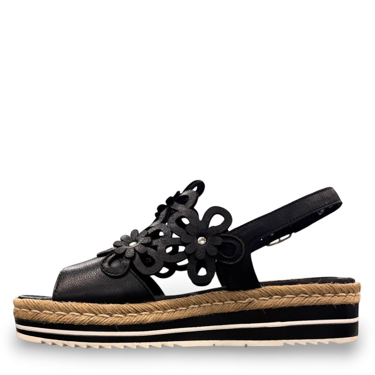 DJANGO & JULIETTE black leather platform sandal with floral cut-outs and woven espadrille trim. left view.