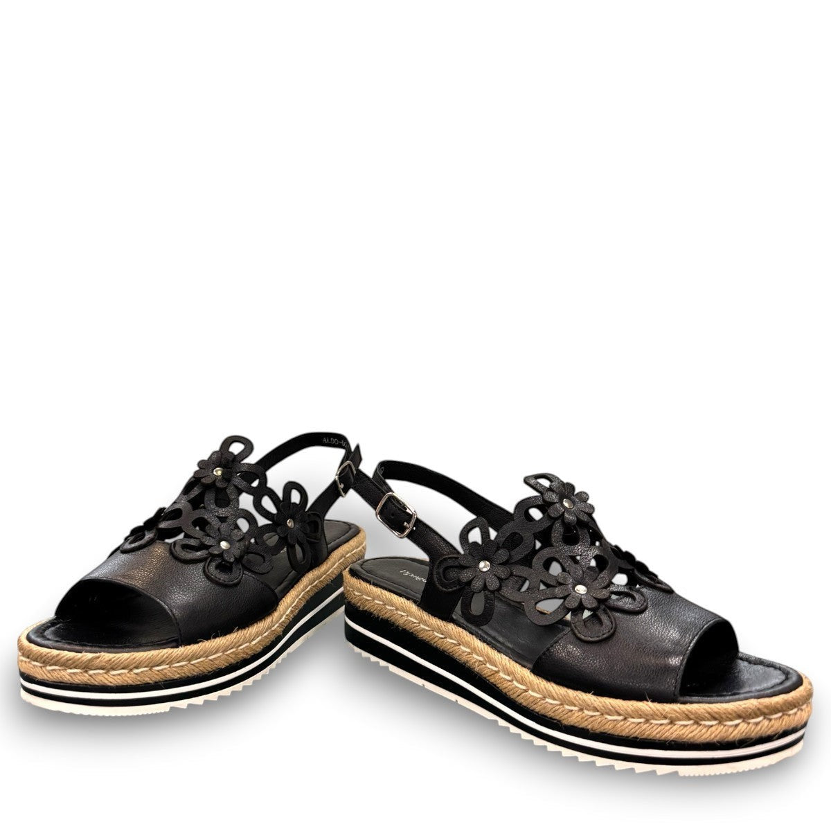 DJANGO & JULIETTE black leather platform sandal with floral cut-outs and woven espadrille trim. front view.