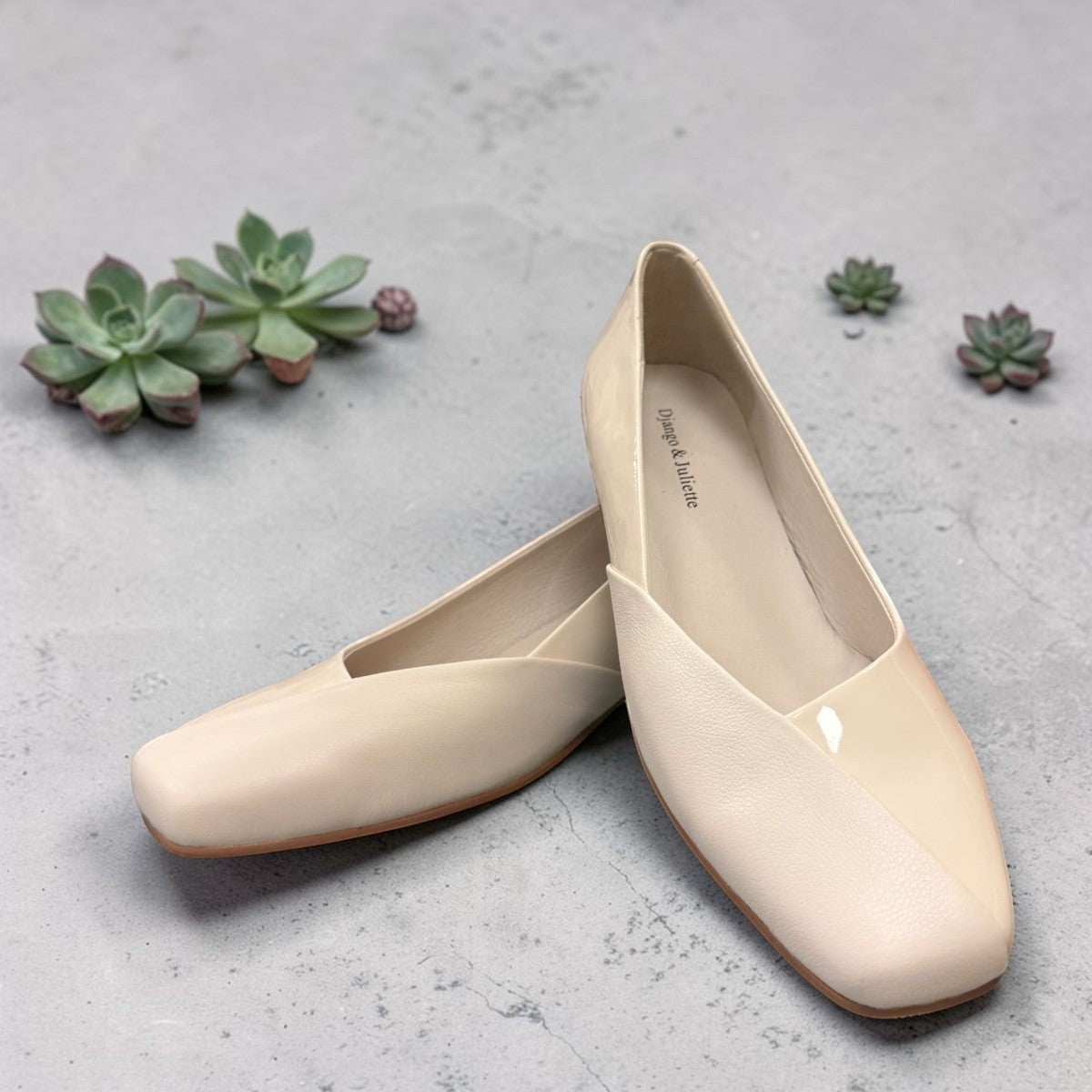 DJANGO & JULIETTE ivory leather and patent block heel pump with a rounded toe and slip-on design. front view.