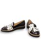 DJANGO & JULIETTE black leather platform loafers with a white and black polka dot bow detail.