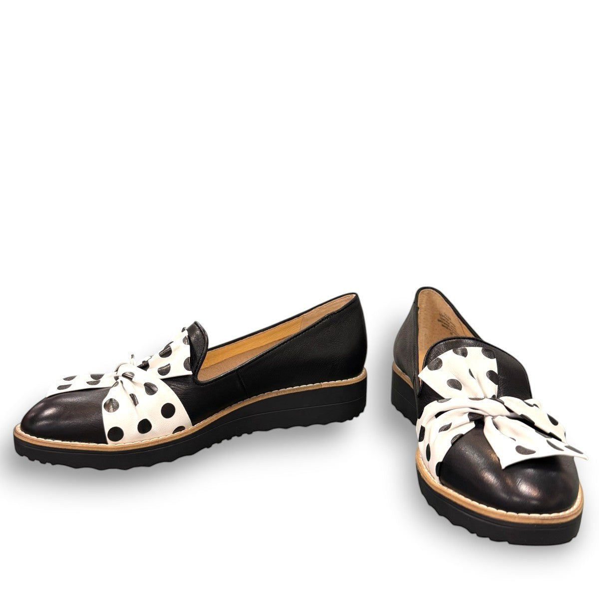DJANGO & JULIETTE black leather platform loafers with a white and black polka dot bow detail.