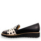 DJANGO & JULIETTE Oclem black leather platform loafer with white and black polka dot bow detail. left view.