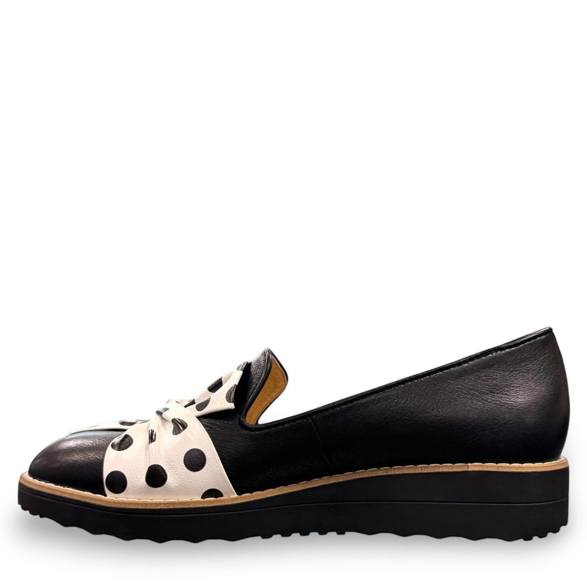 DJANGO & JULIETTE Oclem black leather platform loafer with white and black polka dot bow detail. left view.
