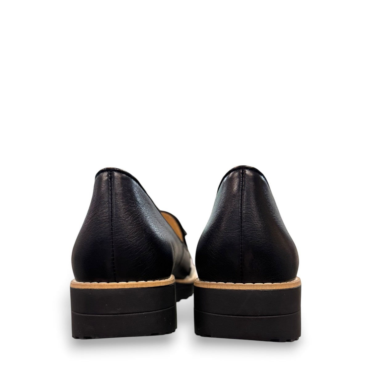 Sina Footwear DJANGO & JULIETTE black leather platform loafers viewed from the back showing the low rubber wedge heel. back view.