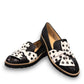 DJANGO & JULIETTE black leather platform loafers with a white and black polka dot bow detail.