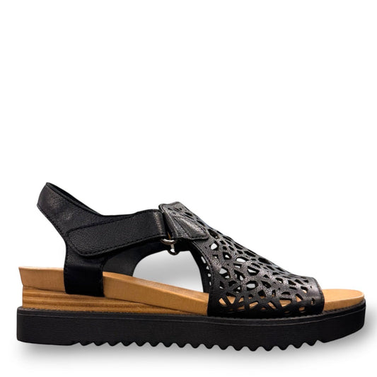 Django & Juliette black leather flatform sandals with intricate laser-cut patterns and sporty soles. right view.