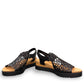 Django & Juliette black leather flatform sandals with intricate laser-cut patterns and sporty soles. front view.