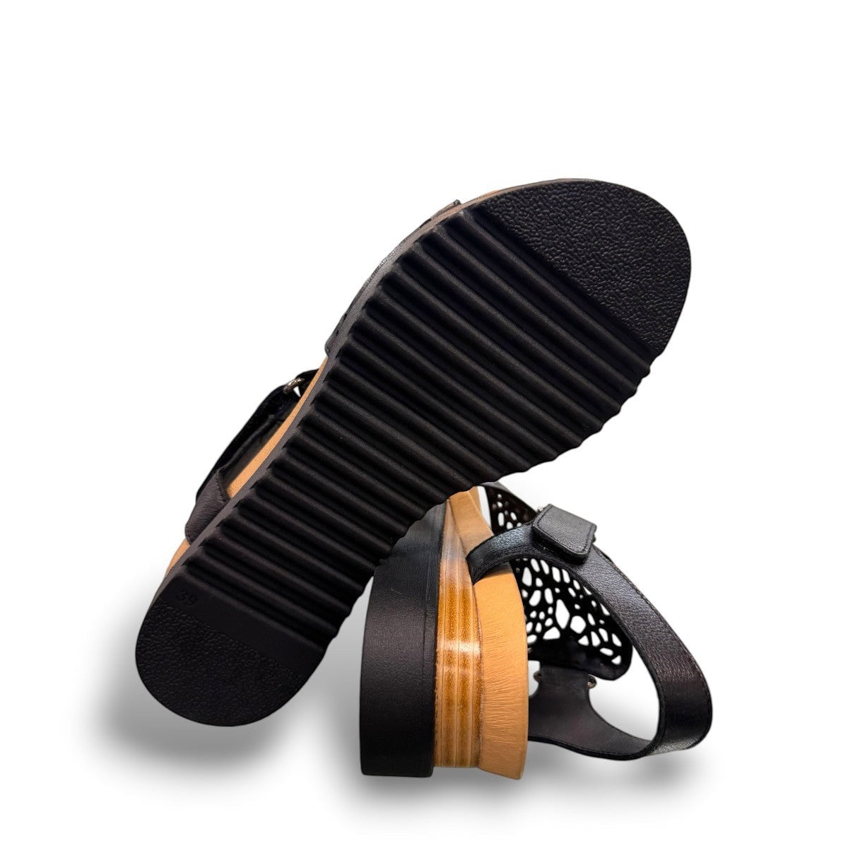 Django & Juliette black leather flatform sandals with intricate laser-cut patterns and sporty soles.
bottom view.