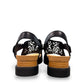 Django & Juliette black leather flatform sandals with intricate laser-cut patterns and sporty soles. back view.