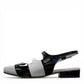DJANGO & JULIETTE Brynns black and white patent leather slingback Mary Jane flat with buckled straps.
left view.