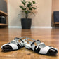 DJANGO & JULIETTE Brynns black and white patent leather slingback Mary Jane flat with buckled straps.
front view.