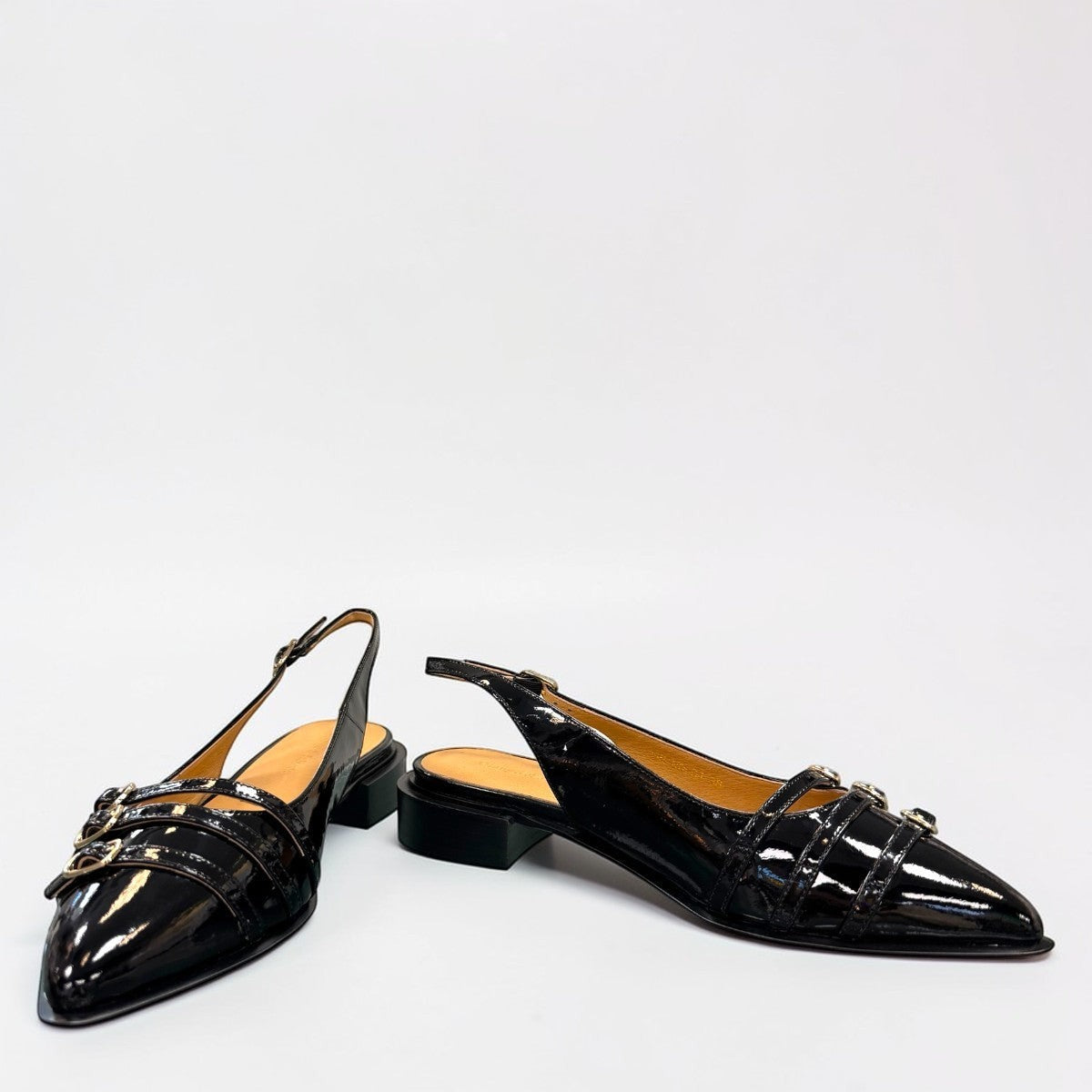 DJANGO & JULIETTE Eshano black patent leather slingback flat with triple buckle detail and low heel. 
front view.