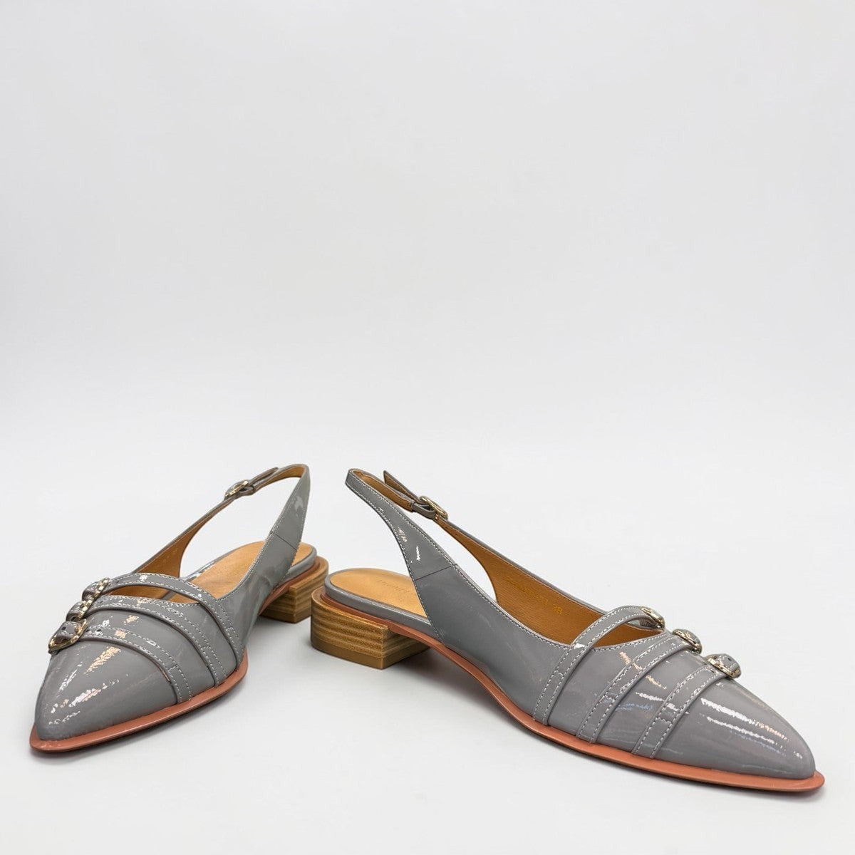 DJANGO & JULIETTE Eshano denim blue patent leather slingback flat with triple buckle detail and low heel. front view.