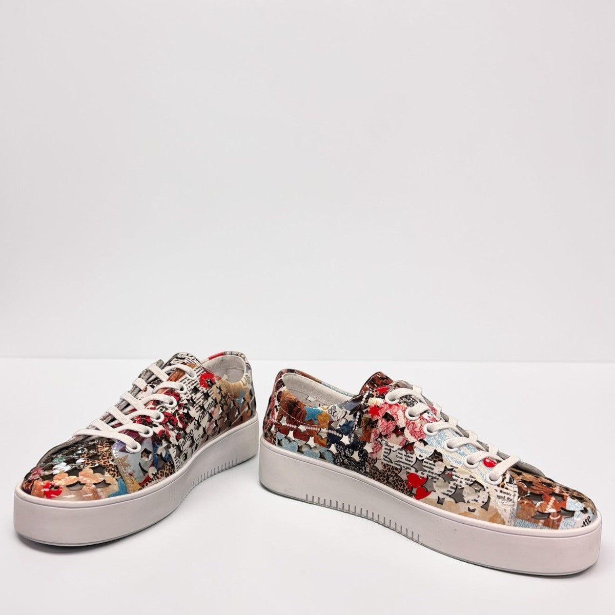 Django & Juliette Leithah leather sneakers featuring a colorful collage print and white platform sole. front view.