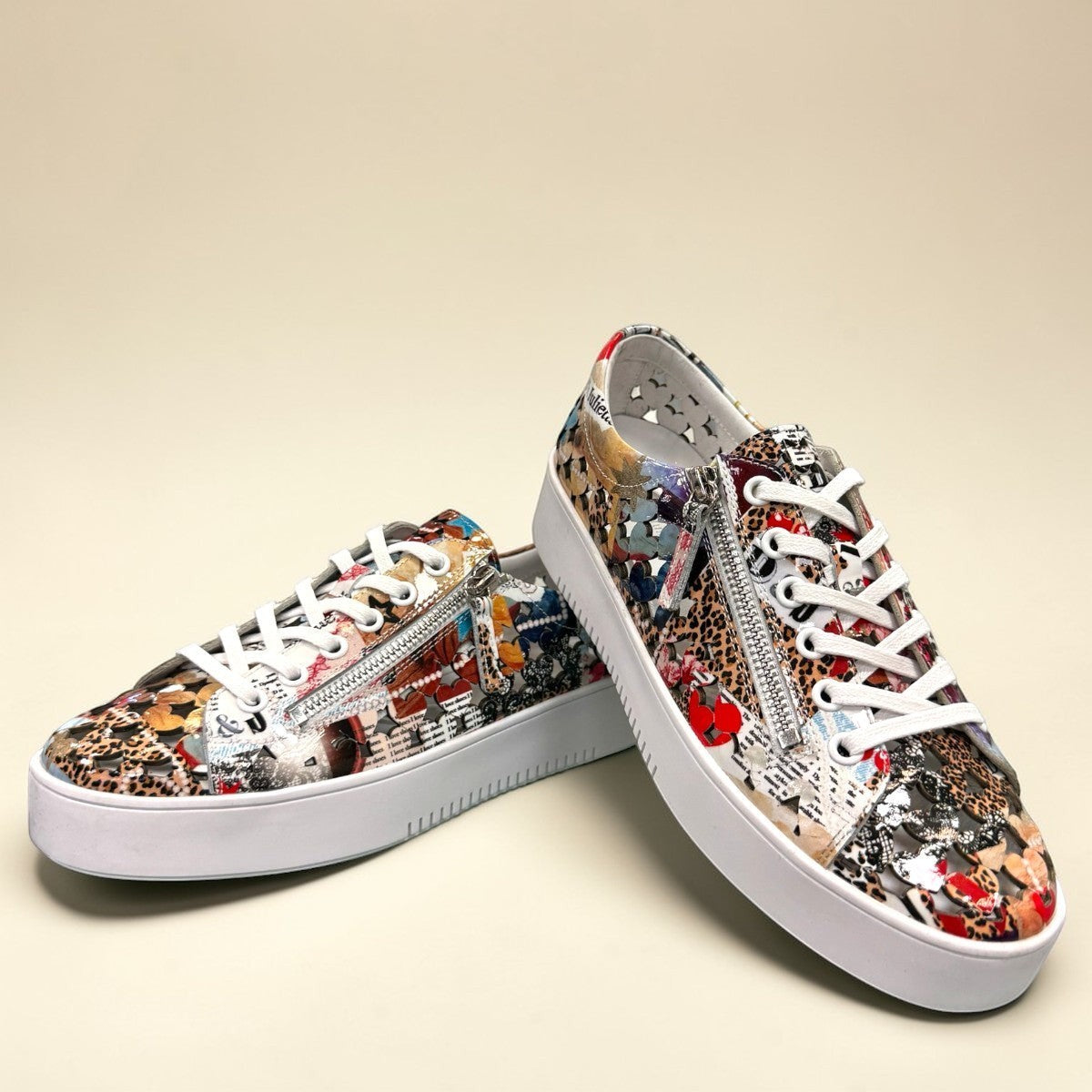Django & Juliette Leithah leather sneakers featuring a colorful collage print and white platform sole. front view.