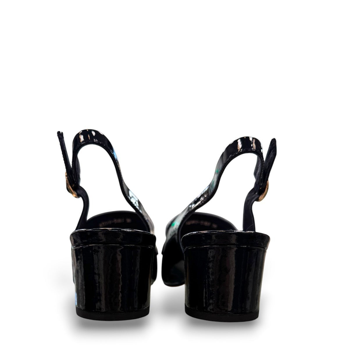Django & Juliette navy patent leather slingback loafers with a 2-inch block heel and adjustable strap.
back view.