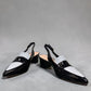 Django & Juliette navy patent leather slingback loafers with a 2-inch block heel and adjustable strap.
front view.