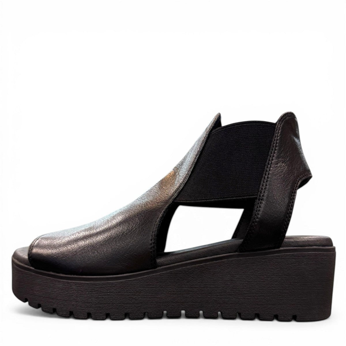 Django & Juliette Ozie black leather wedge sandal with elastic straps and a 2-inch platform sole. left view.