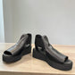 Django & Juliette Ozie black leather wedge sandal with elastic straps and a 2-inch platform sole.  front view.
