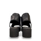 Django & Juliette Ozie black leather wedge sandal with elastic straps and a 2-inch platform sole. back view.