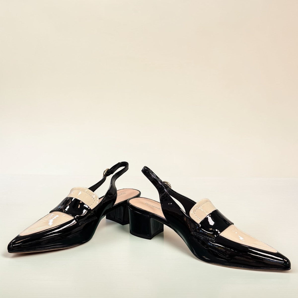 Django & Juliette Aiday black and ivory patent leather slingback block heel shoe with adjustable strap. front view.