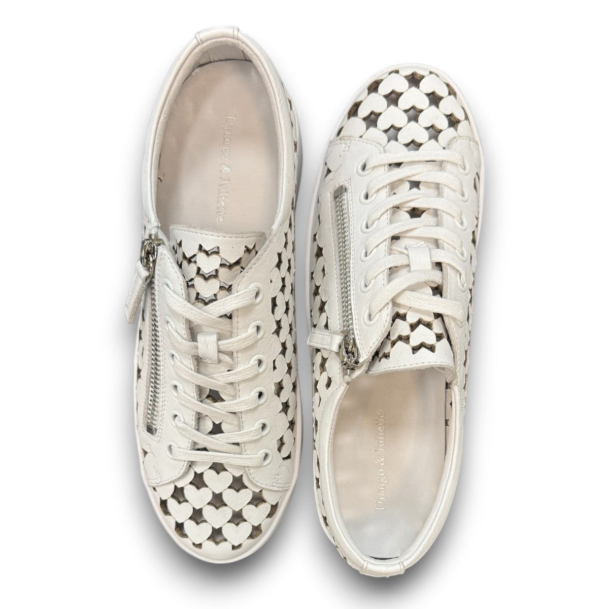 Django & Juliette white leather platform sneakers with heart-shaped laser cutouts and side zipper. top view.