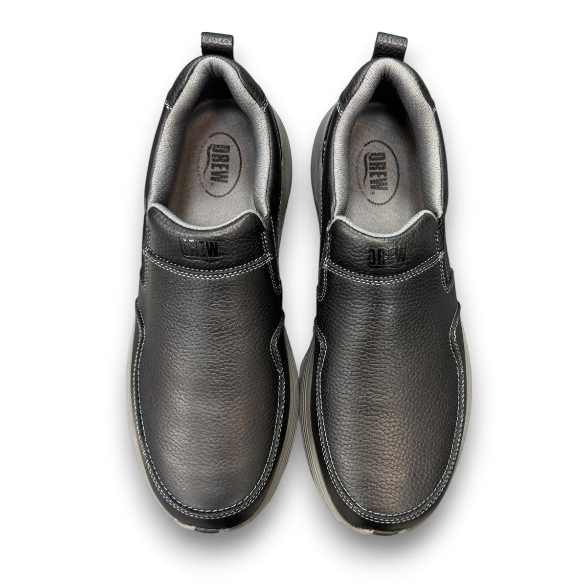 Drew Match black pebbled leather slip-on shoe showing the textured rubber rocker bottom outsole