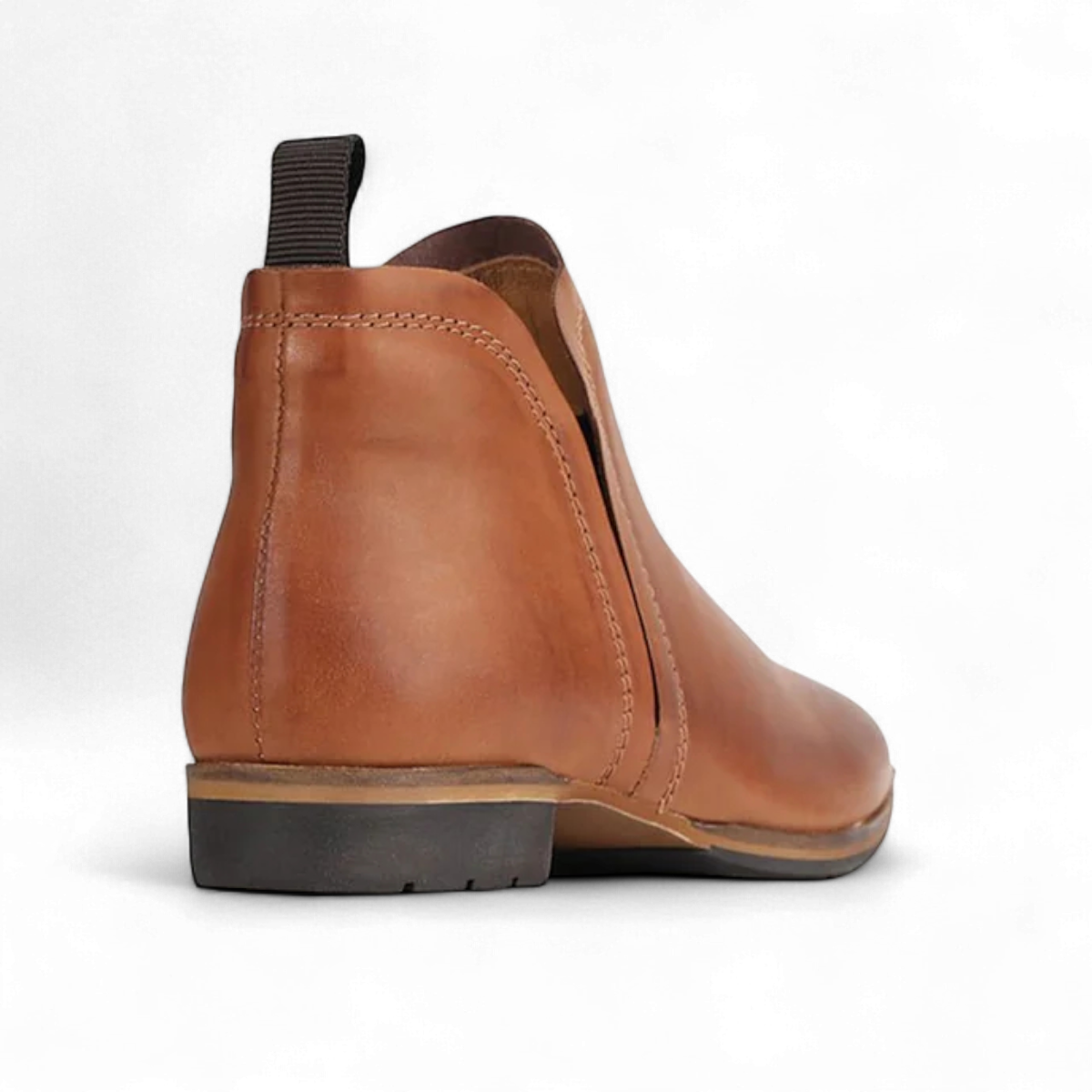 EOS MELBORN GAID brandy leather ankle boots with elastic side gussets and a pull tab on a rubber outsole. Photo of back side view.