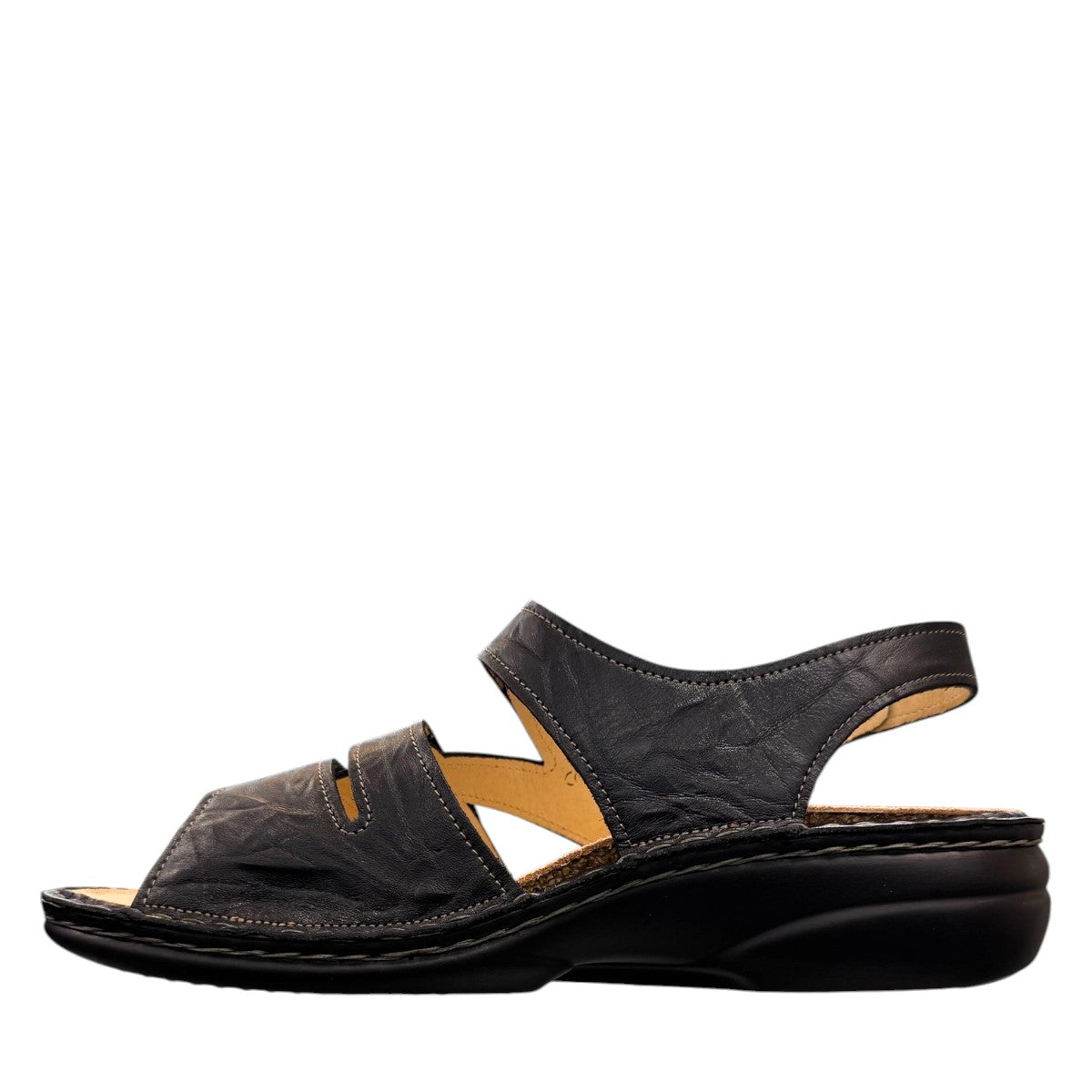 Finn Comfort Gomera black leather sandal with adjustable hook and loop straps and cork footbed.
photo of the left side