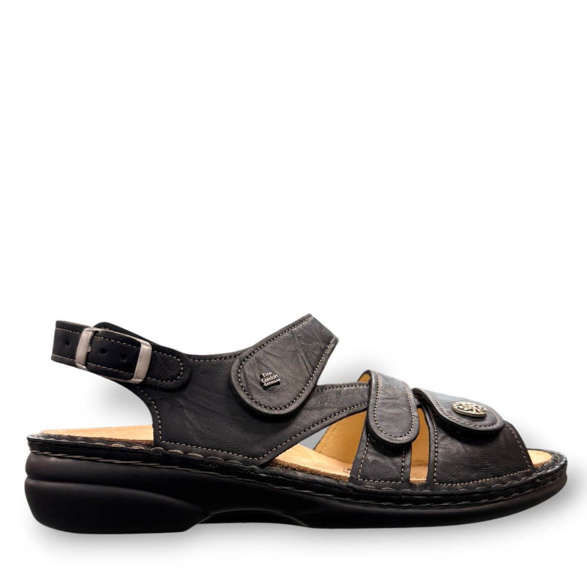 Finn Comfort Gomera black leather sandal with adjustable hook and loop straps and cork footbed.
photo of the right side