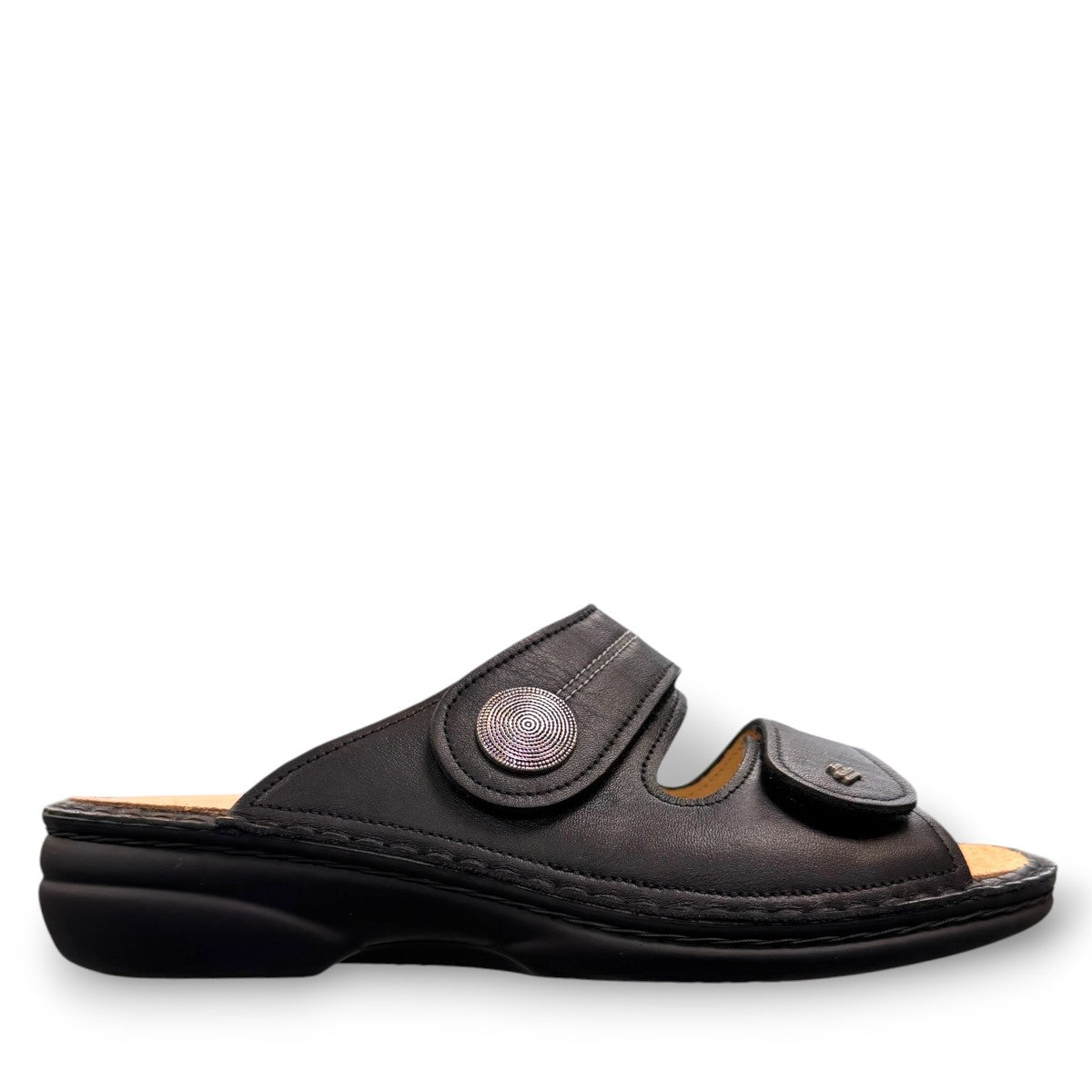 Finn Comfort Sansibar black leather sandal with two adjustable straps and decorative silver button.
photo of the right side