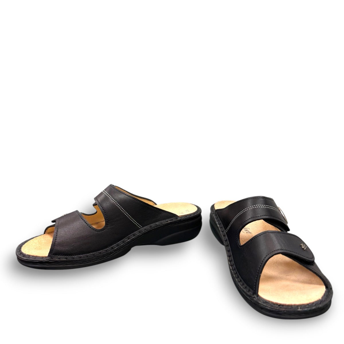 Finn Comfort Sansibar black leather sandal with two adjustable straps and decorative silver button.
photo of the front side