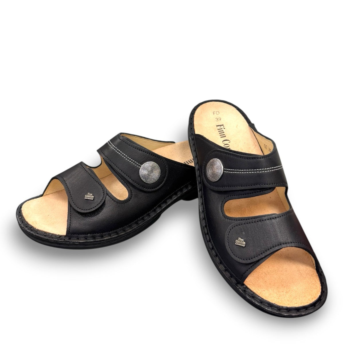 Finn Comfort Sansibar black leather sandal with two adjustable straps and decorative silver button.
photo of the front side