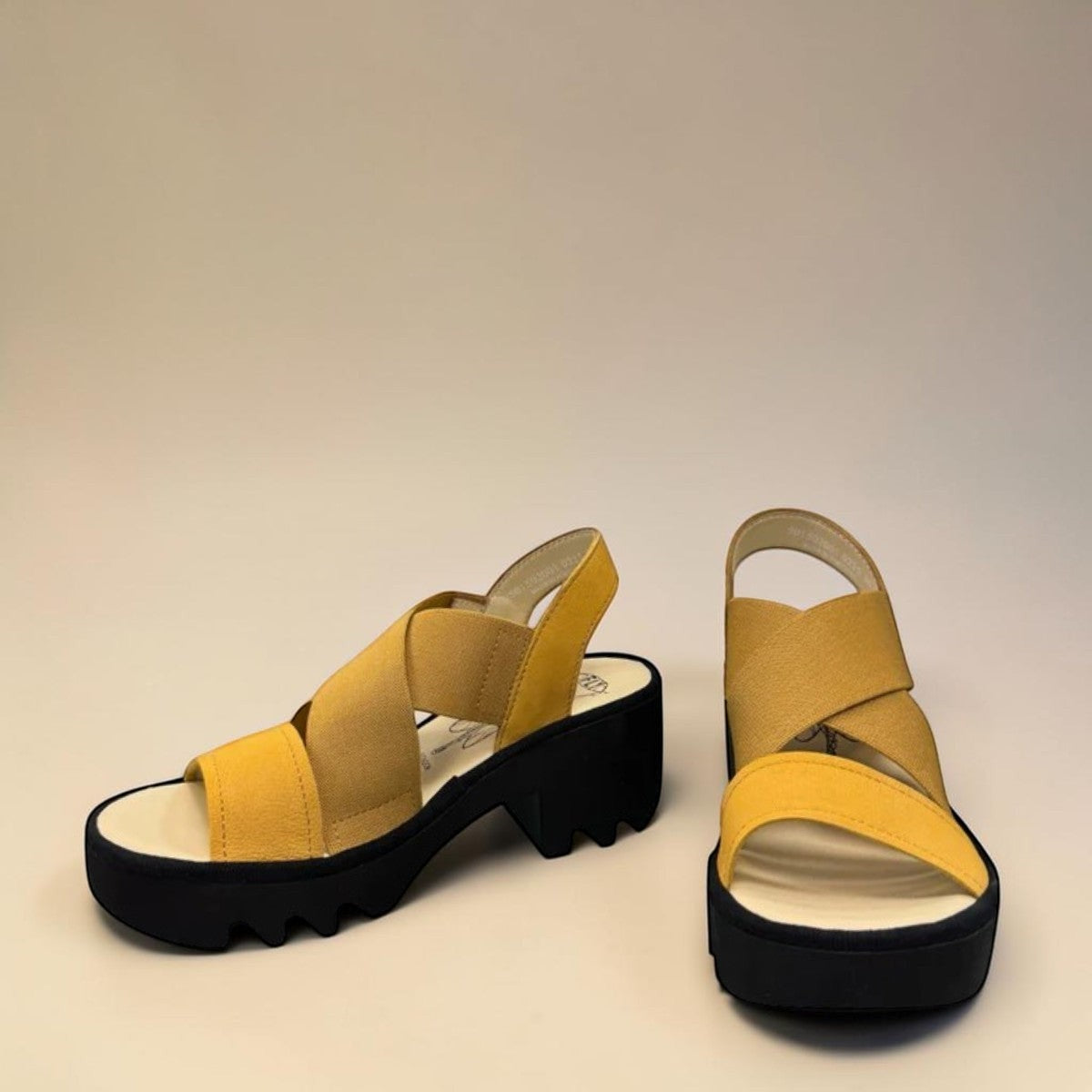 Fly London Taji502fly cupido bumblebee yellow elastic and leather platform sandals with a chunky lugged rubber sole.