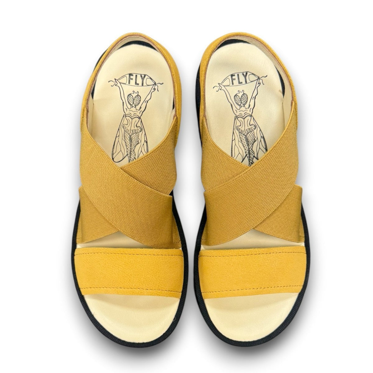 Fly London Taji502fly cupido bumblebee yellow elastic and leather platform sandals with a chunky lugged rubber sole.