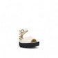Fly London off-white leather sandals with a chunky black rubber platform sole and ankle strap.