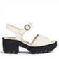 Fly London off-white leather sandals with a chunky black rubber platform sole and ankle strap.