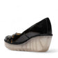 Fly London Yubi480fly- nappalak black patent leather wedge shoe with cut-out details and a translucent rubber sole.