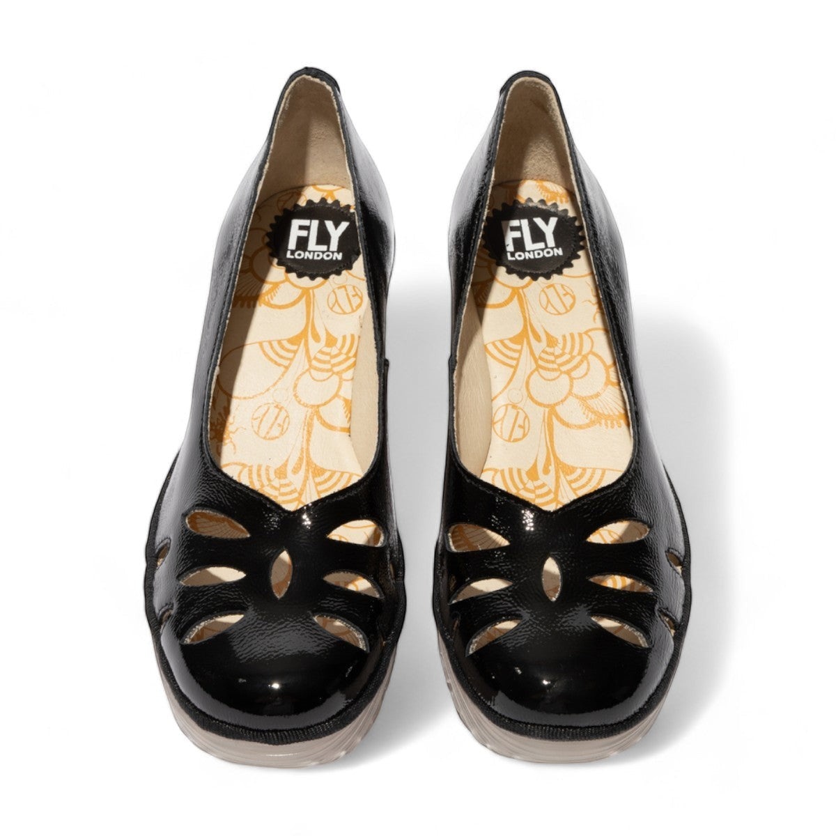 Fly London Yubi480fly- nappalak black patent leather wedge shoe with cut-out details and a translucent rubber sole.