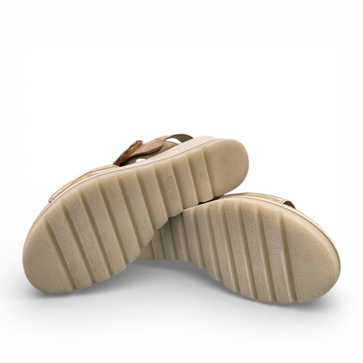 Gabor wedge sandal in metallic gold and suede puder with a decorative buckle and velcro strap. Photo of bottom view.