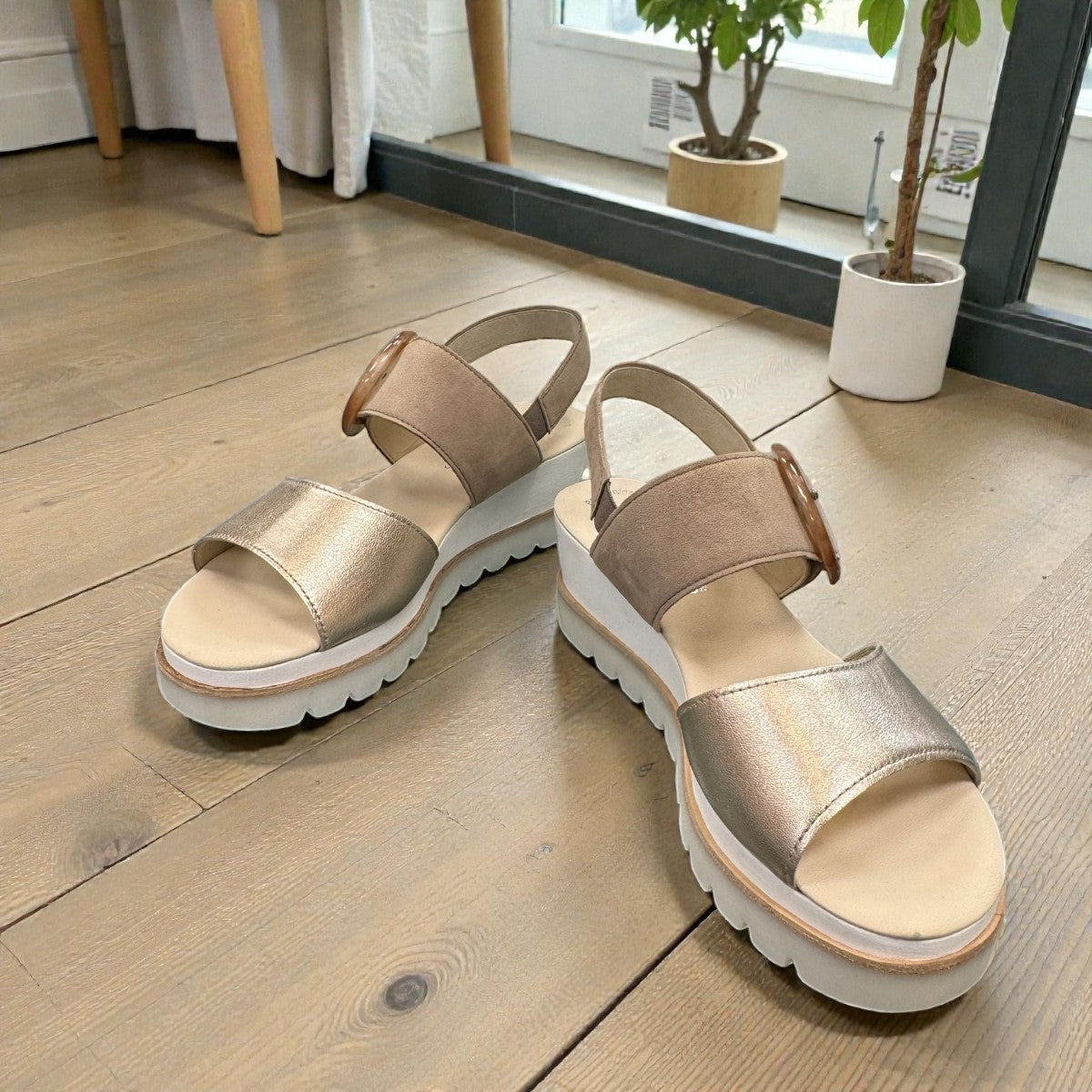 Gabor wedge sandal in metallic gold and suede puder with a decorative buckle and velcro strap. Photo of front side view 2.