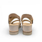 Gabor wedge sandal in metallic gold and suede puder with a decorative buckle and velcro strap. Photo of back view.