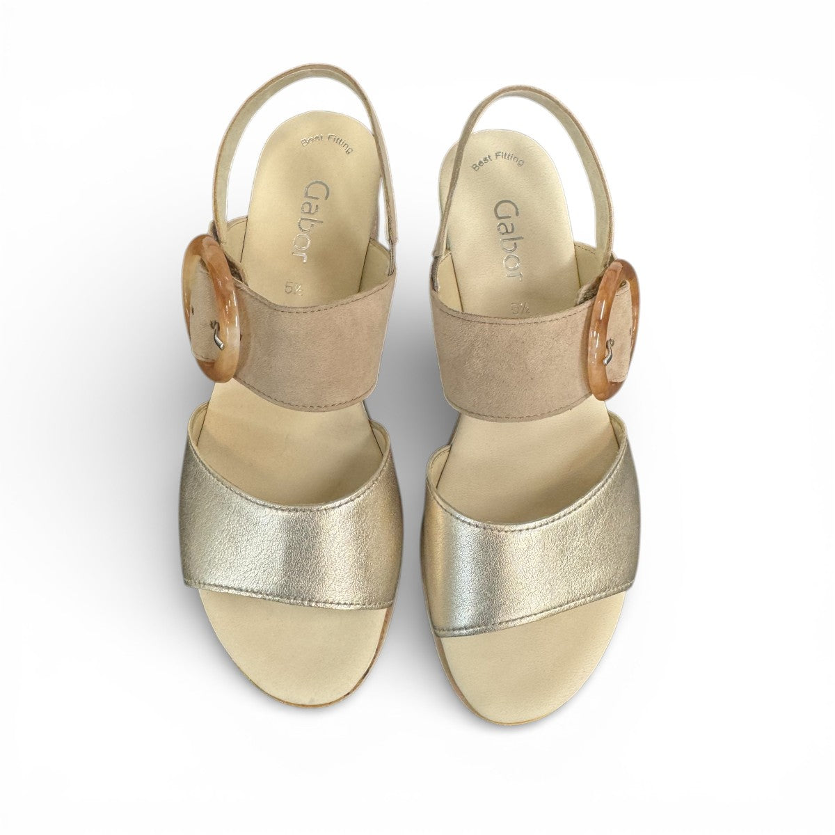 Gabor wedge sandal in metallic gold and suede puder with a decorative buckle and velcro strap. Photo of upper view.
