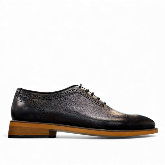 Gest Gentle black leather lace-up dress shoe with brogue detailing and a contrast tan rubber outsole. Photo of right side view.
