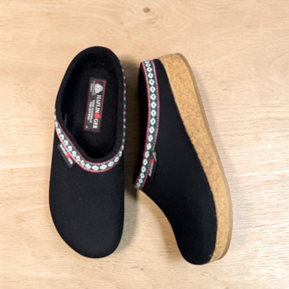 Haflinger GZ black wool felt clog with decorative trim and anatomically contoured cork midsole. Photo of upper view 1.