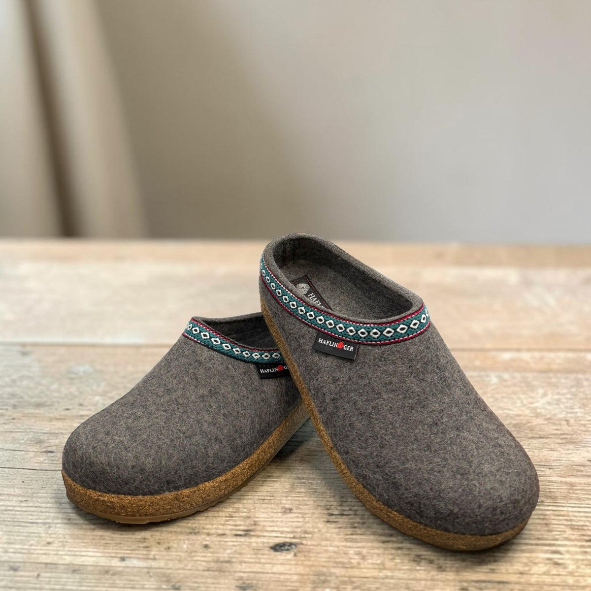 Haflinger GZ gray wool felt clog with patterned trim and anatomically contoured cork midsole. Photo of front side view.