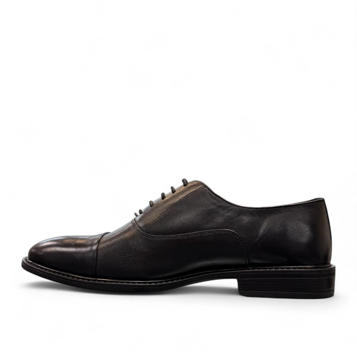 Horn Shoes Arjhand black leather oxford shoes with a classic cap toe design and lace-up closure. Photo of left side view.