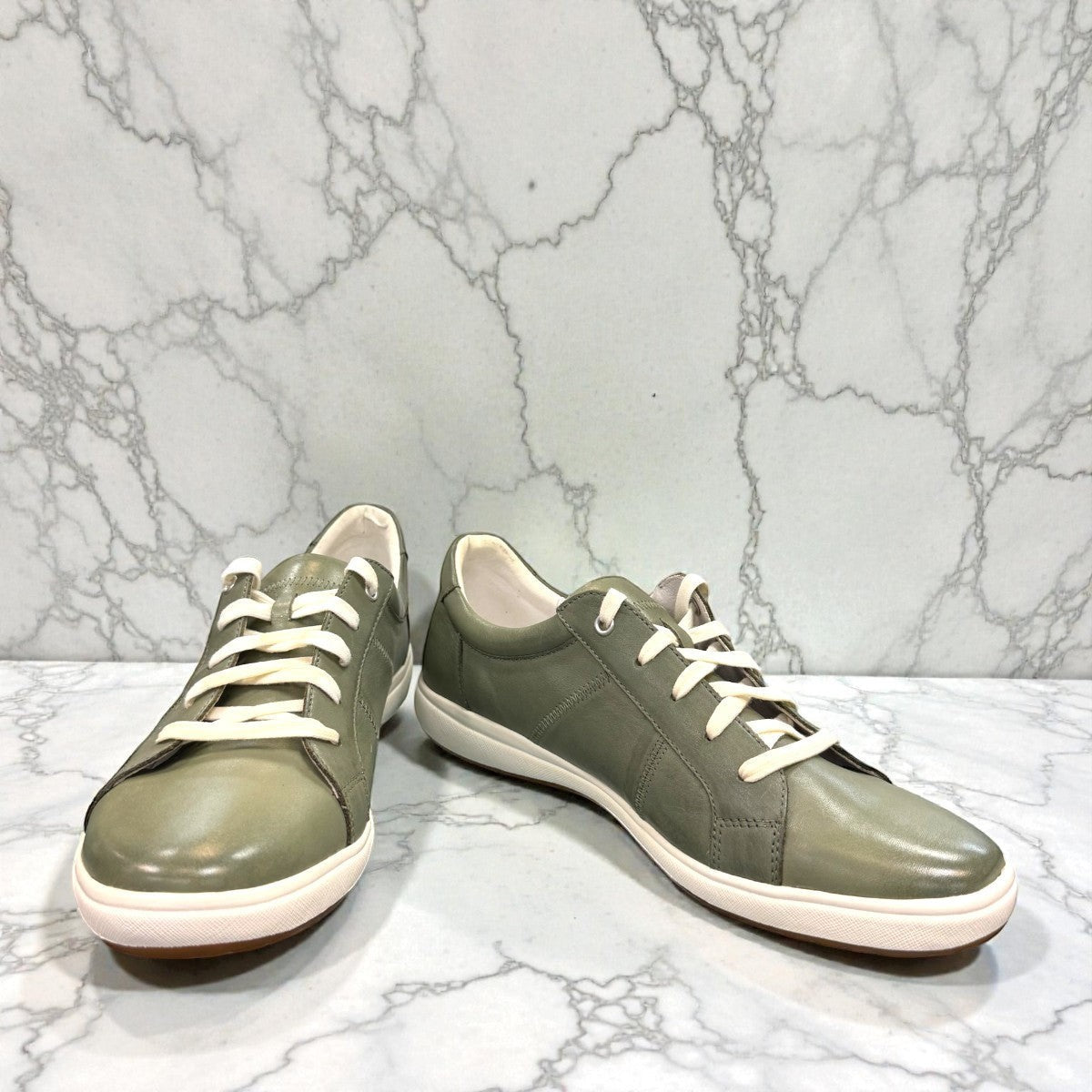 Josef Seibel Caren 01 mint green leather lace-up sneaker with perforated side detail and rubber sole. photo of the front.