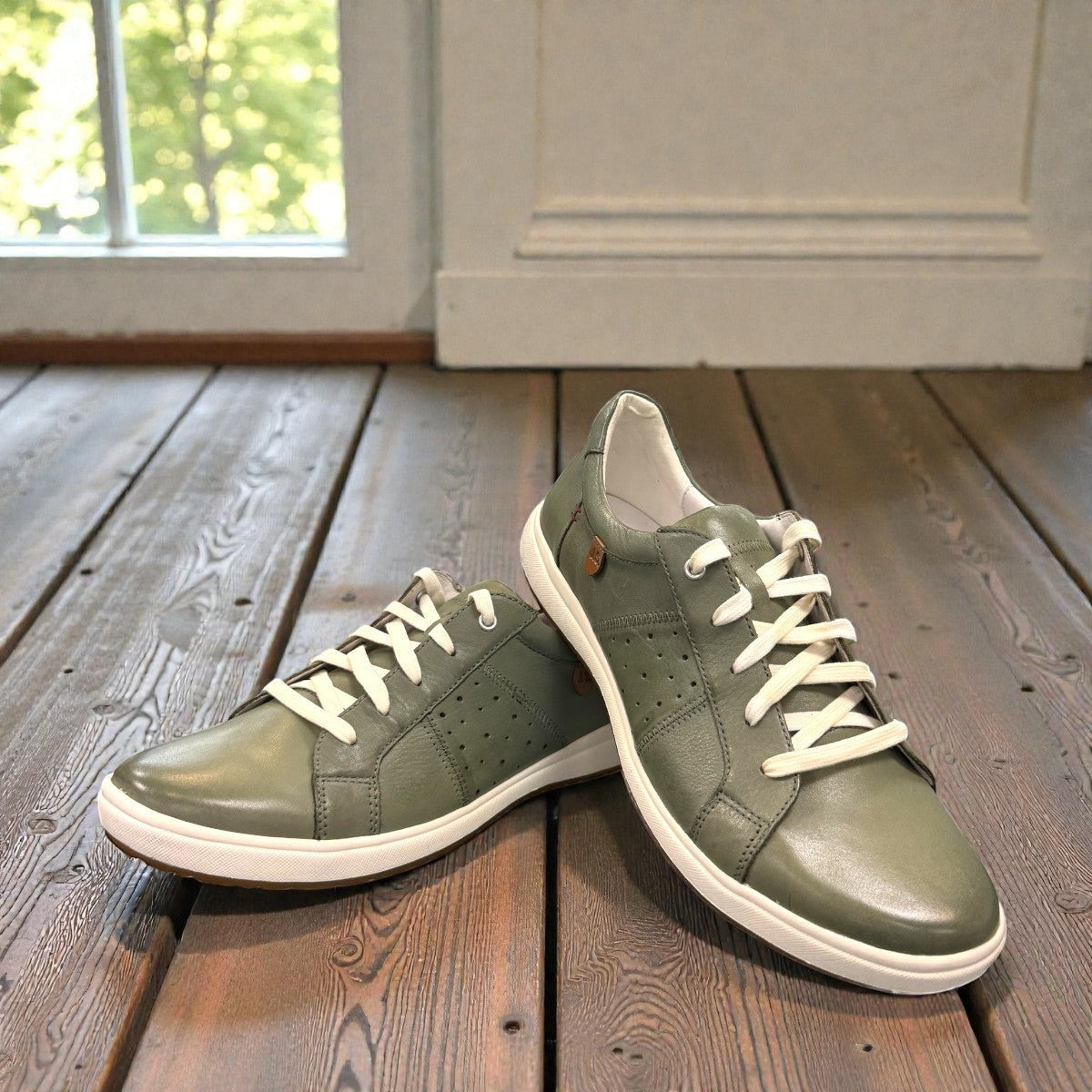 Josef Seibel Caren 01 mint green leather lace-up sneaker with perforated side detail and rubber sole. photo of the front.