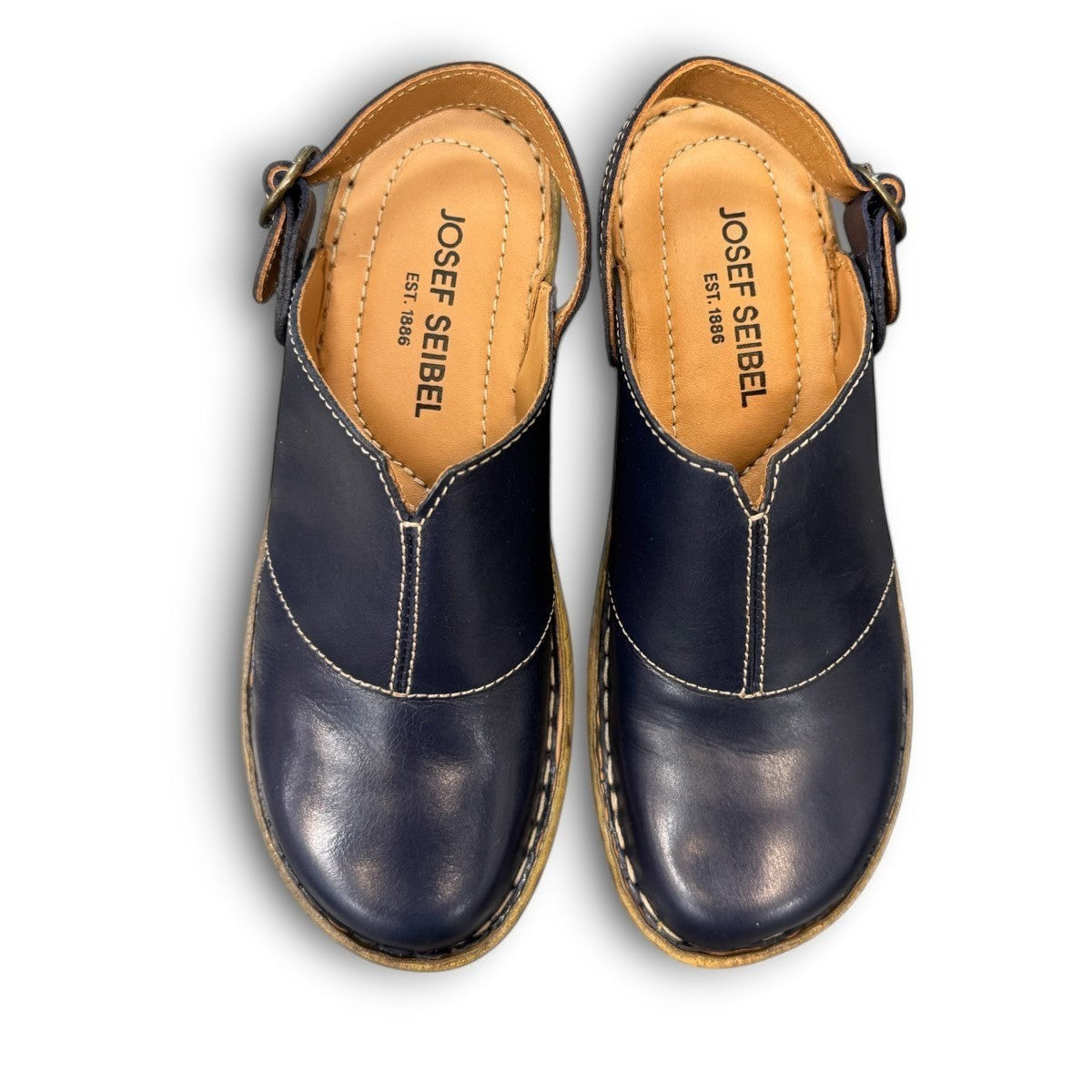 JOSEF SEIBEL Catalonia 83 indigo leather clogs with a decorative buckle and sturdy wood-look PU sole.